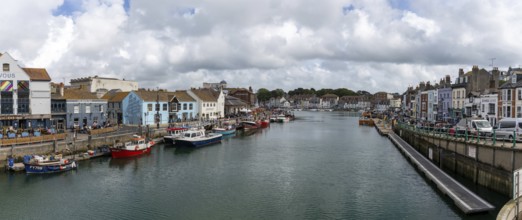 Weymouth, United Kingdom, 7 September, 2022: downtown Weymouth and fishing boats on the River Wey