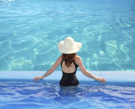 Caribbean tropical sea view from blue pool rear woman beach hat