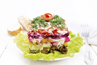 Puff salad with beef, boiled potatoes and beets, pears, spicy carrots, seasoned with mayonnaise and