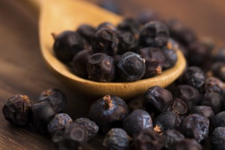 Juniper berries on a wooden background