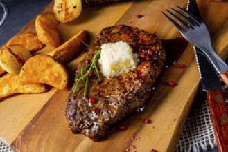 Butter beef steak with herbs and potato wedges