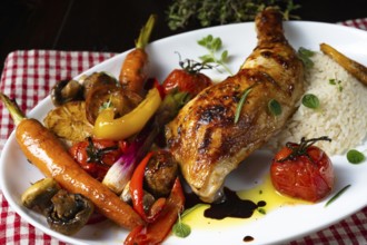 Rustic fried chicken legs with assorted vegetables and rice