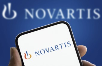 Novartis logo is displayed on smartphone. Novartis AG is a Swiss multinational pharmaceutical