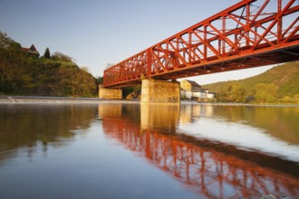 The old iron railway bridge over the river at sunset