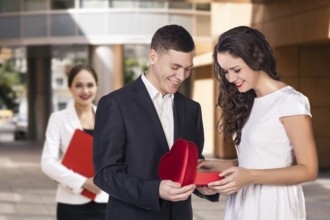Happy young business women with a folder at the office building