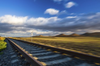 Single railway track at sunset, Central Bohemian Uplands, Czech Republic. Railway track in nature