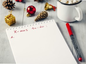 Christmas gifts shopping planning. Make shopping or to-do list for Christmas. Notebook, mug hot