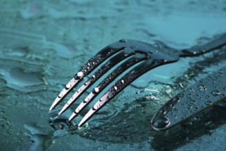 Fork and knife under the blue water