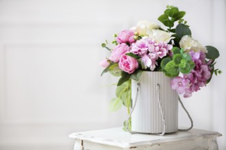 Beautiful peonies in a paper box on a white background