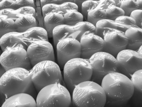 Candles in plastic wrap. Background. Pattern