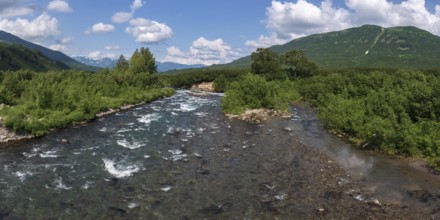 Stunning summer panoramic landscape of Kamchatka Peninsula: view of stream clear water of mountain