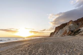 The golden sandy beach of Praia da Falésia with its characteristic orange-coloured cliffs,