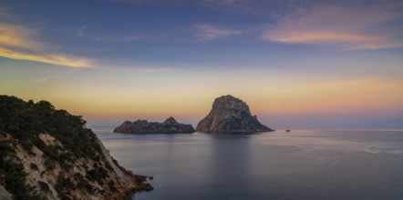 A panorama landscape view of the landmark Es Vedra island and rocks off the coast of Ibiza at