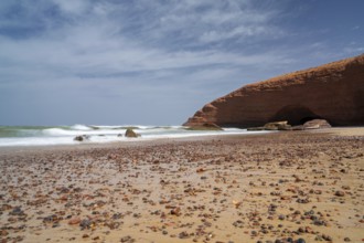 A long exposure view of the beach and rock arch at Legzira on the Atlantic Coast of Morroco
