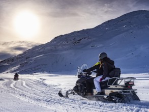 Snowmobile on a trail in the Italian alps