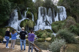 Kravica waterfalls, tourists photographing the waterfall, Trebižat river, near the village of