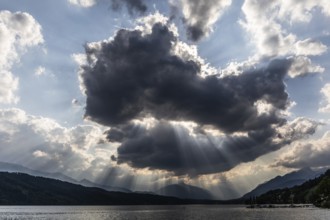 Cloudy mood over Lake Millstättersee, sunbeams from clouds, near Millstatt, Carinthia. Austria
