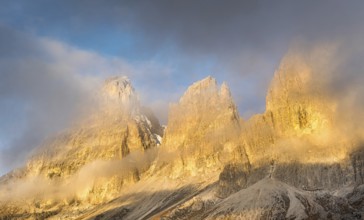 Foggy mountain landscape during sunrise of the picturesque Dolomiti at Passo Sella area in South