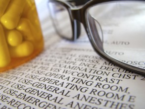 Closeup Of A Medical Hospital Bill, Prescription Medicine And Glasses