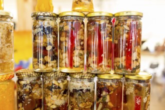 Honey with dried fruits and dried nuts - walnuts, hazelnuts, peanuts, almonds, cashews, plums,
