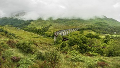 Glenfinnan railway viaduct (location from Harry Potter movie), on overcast day with grey sky and