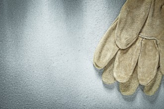 Safety gloves on concrete background construction concept