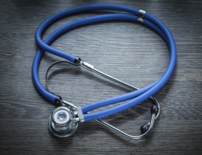 Stethoscope on vintage wooden board horizontal image