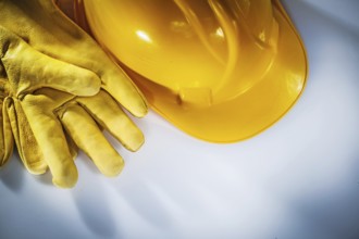 Leather protective gloves building helmet on white background