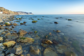Stony sea beach of the 40th anniversary of the victory of the high coast of Anapa at sunset, Black