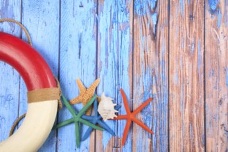 Beach poster on wooden background with starfishes and life buoy