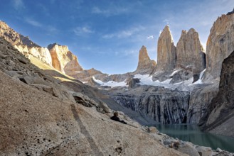 High cliffs next to a turquoise-coloured lake in a remote landscape, The rock towers of Torres del