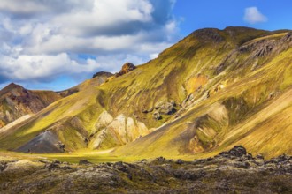 Travel to Iceland in the July. Summer volcanic tundra. Multi-colored mountains from mineral