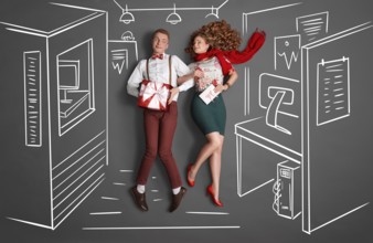 Happy valentines love story concept of an office romance. Young couple at work smiling at each