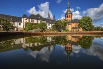 A historic monastery in the morning. Monastery walls, church and buildings are reflected in the