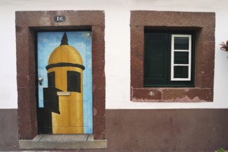 House wall with colourfully painted door, Madeira