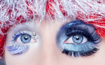 Asymmetrical christmas concept eye makeup winter red silver macro closeup