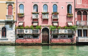 Ancient buildings in Venice. Boats moored in the channel. View from the side of the water