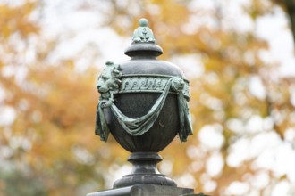 Ancient burial urn in a historic cemetery in autumn