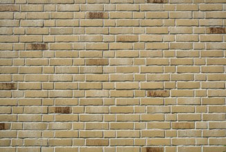 Background made from a wall of beige clinker bricks