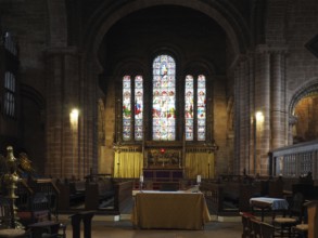 Chester. Cheshire, United Kingdom, 20 March 2024 : The alter and stained glass windows in St John