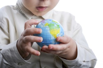 Baby holding a small globe in hand on white background