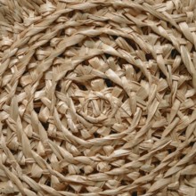 Circular pattern of woven seagrass basket. Abstract background - natural rattan or sea grass in
