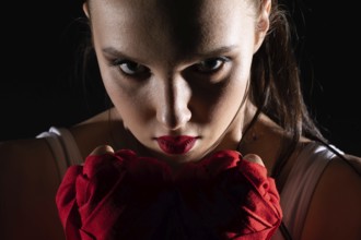 The head is hidden behind the strong guard of a professional sportswoman. A strong and athletic