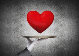 Cropped image of waitress's hand in white glove presenting big red heart on metal tray with dark