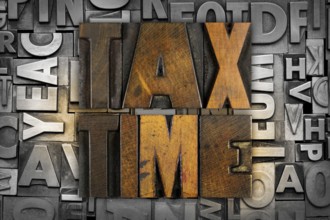 The words TAX TIME written in vintage letterpress type