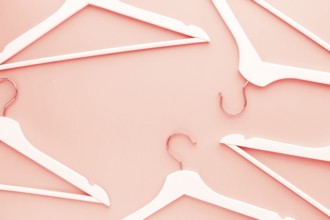 Creative top view flat lay wooden hangers toned living coral color of the year 2019 background copy