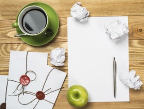 Top view of creative writing concept with papers on wooden table