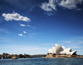 Famous sydney landmark opera house view with ferry boat in australia on sunny day