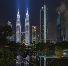 A picture of the Petronas Twin Towers as seen from the KLCC Park at night