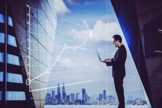 Businessman using laptop with graph statistical analysis, Business success concept